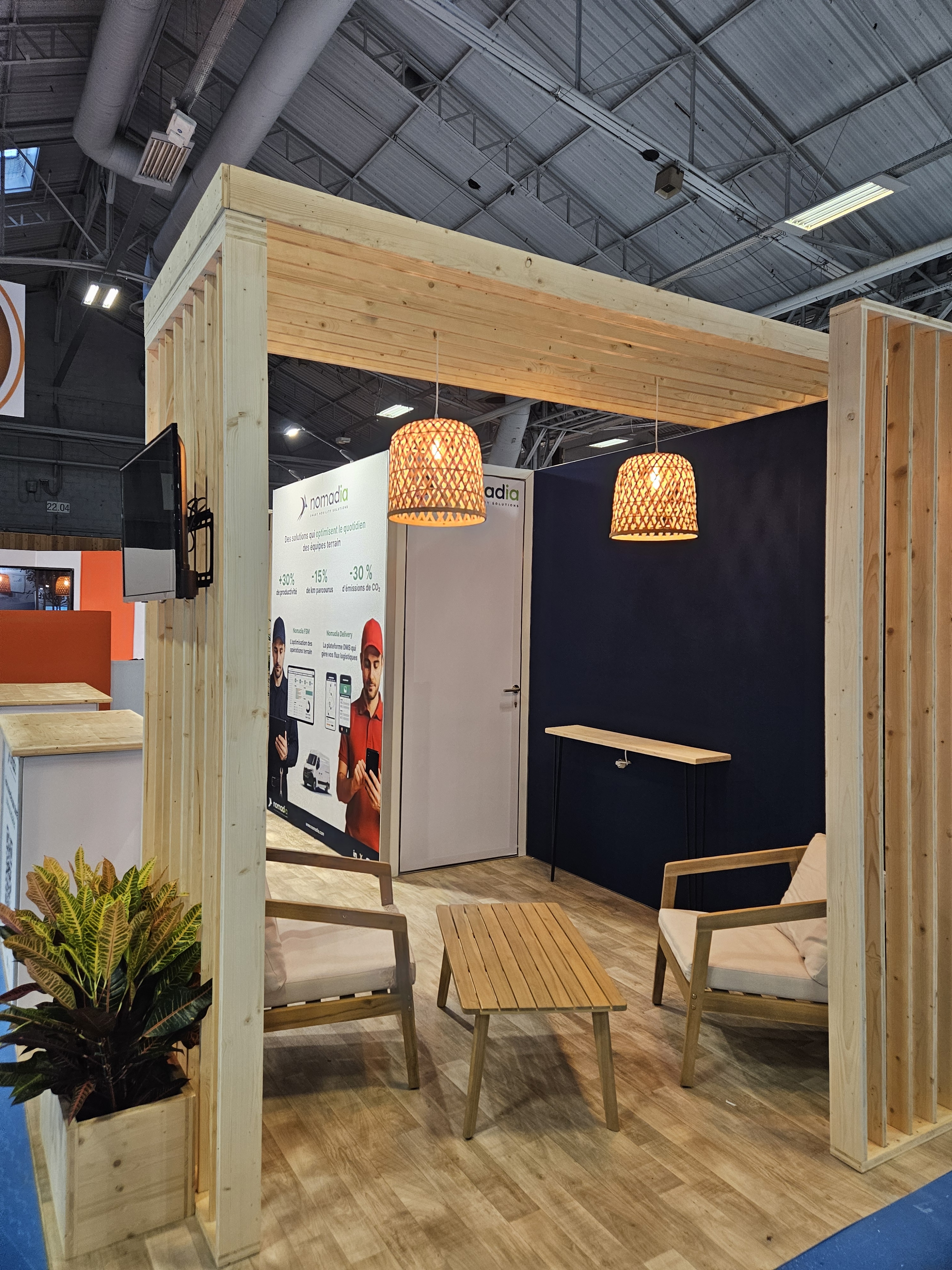 Claustra en bois et luminaires suspendus du stand de Nomadia au salon Mobility For Business 2025